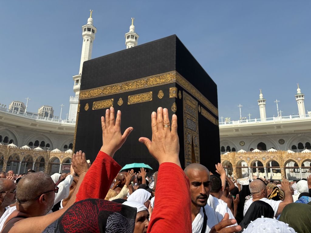FILE - Muslim pilgrims pray as they circumambulate the Kaaba, the cubic building at the Grand Mosque, during the minor pilgrimage, known as Umrah, in the Muslim holy city of Mecca, Saudi Arabia, Sunday, Dec. 7, 2025. (AP Photo/Amr Nabil, File)