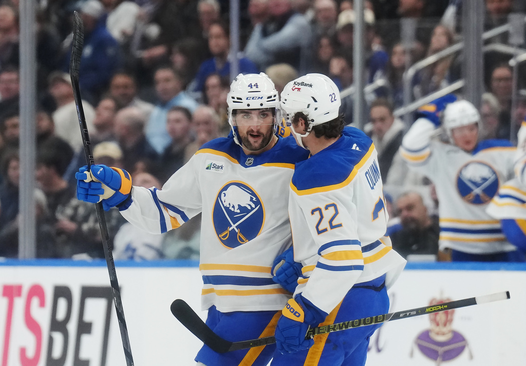 Buffalo Sabres' Dennis Gilbert (44) celebrates with Jack Quinn (22) after scoring against the Toronto Maple Leafs during the third period of an NHL hockey game in Toronto, Thursday, Oct. 15, 2026. (Nathan Denette/The Canadian Press via AP)