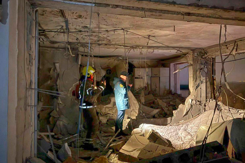 This photo released by Moscow Region Governor Andrei Vorobyev official telegram channel shows investigators working in the damaged multi-storey apartment building hit by a Ukrainian drone in Krasnogorsk, just outside Moscow, Russia, on Friday, Oct. 24, 2025. (Moscow Region Governor Andrei Vorobyev official telegram channel via AP)