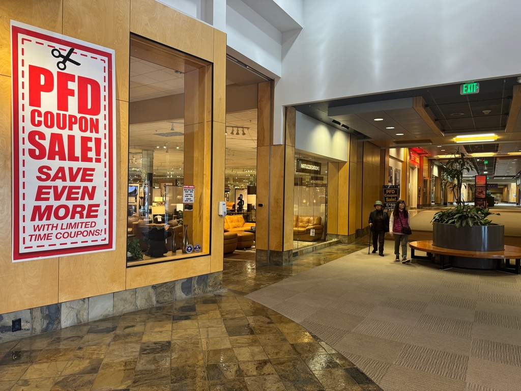 A sale advertisement related to the issuance of Alaska Permanent Fund Dividend, or PFD, checks hangs outside a furniture store in Anchorage, Alaska, Tuesday, Sept. 23, 2025. (AP Photo/Mark Thiessen)