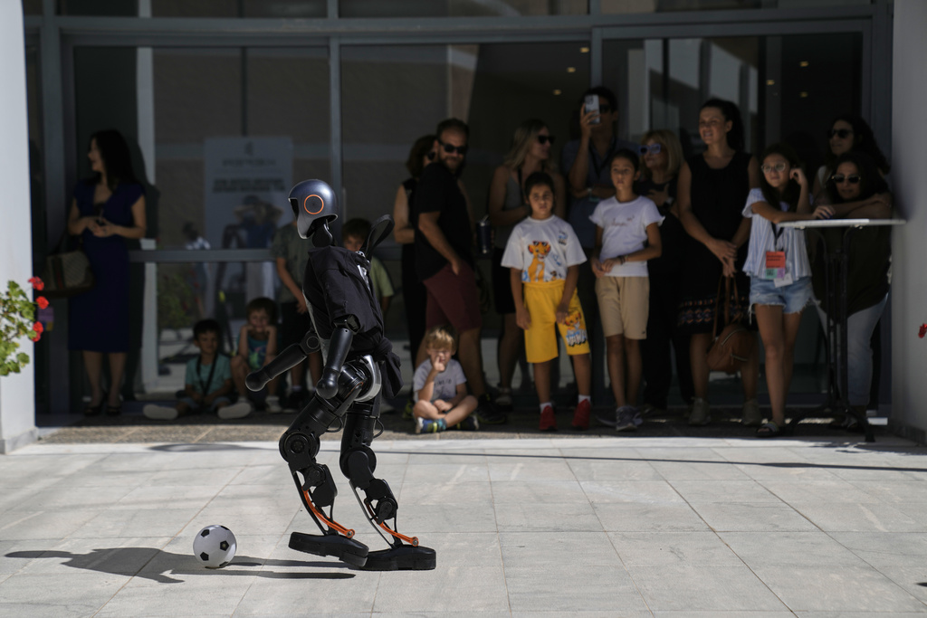 The Booster T1 robot plays soccer at the first International Humanoid Olympiad at the Olympic Academy, in ancient Olympia, Greece, Monday, Sept. 1, 2025. (AP Photo/Thanassis Stavrakis)