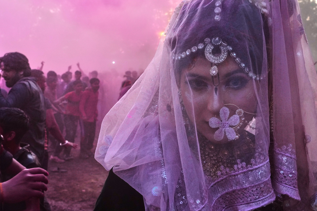 A member of transgender community dances during Holi festival celebrations at the Shri Krishna Janmabhoomi Temple complex in Mathura, India, on Feb. 27, 2026. (AP Photo/Manish Swarup)