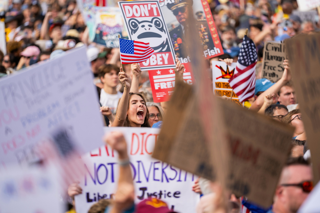 Crowds gather to listen to Sen. Bernie Sanders, I-Vt., during a No Kings protest, Saturday, Oct. 18, 2025, in Washington. (AP Photo/Allison Robbert)