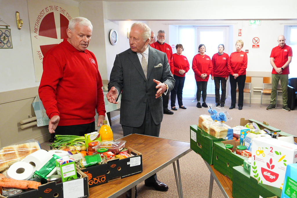 Britain's King Charles III, center, meets volunteers at The Pantry Foodbank in Donard Methodist Church, Newcastle, Northern Ireland, Wednesday, May 20, 2026. (Aaron Chown/PA via AP)