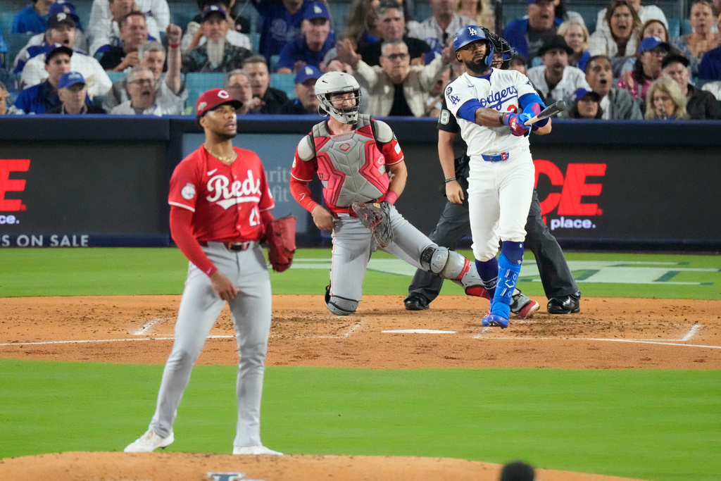 Los Angeles Dodgers' Teoscar Hernández follows through on a three-run home run during the third inning in Game 1 of the National League Wild Card baseball playoff series against the Cincinnati Reds, Tuesday, Sept. 30, 2025, in Los Angeles. (AP Photo/Mark J. Terrill)