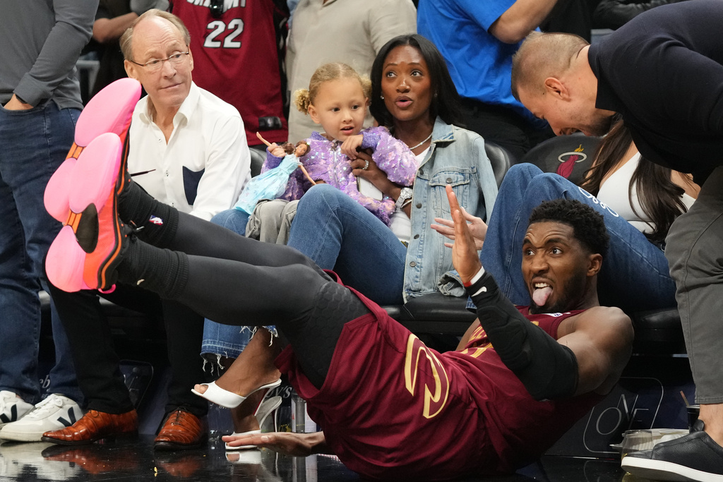 Cleveland Cavaliers guard Donovan Mitchell (45) gestures after scoring a three-point basket during overtime at an NBA basketball game against the Miami Heat Monday, Nov. 10, 2025, in Miami. (AP Photo/Marta Lavandier)