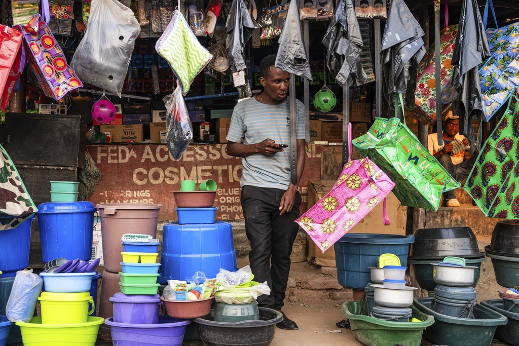 A man walks through an outdoor shop in Blantyre, Malawi, Tuesday, Sept. 16, 2025. (AP Photo/Thoko Chikondi)
