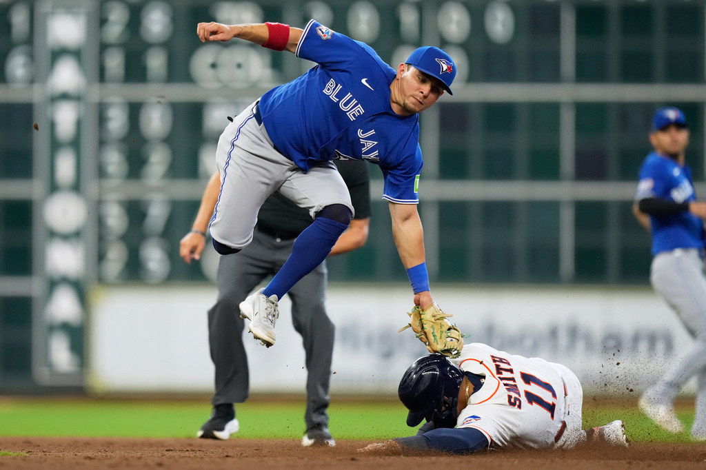 Toronto Blue Jays second baseman Luis Urías tags out Houston Astros right fielder Cam Smith (11) at second base during the eighth inning of a baseball game in Houston, Wednesday, Aug. 5, 2026. (AP Photo/Ashley Landis)