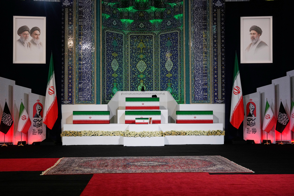 The coffins of slain Iranian Supreme Leader Ayatollah Ali Khamenei, center on top, and members of his family are displayed ahead of the dayslong funeral ceremonies at the Imam Khomeini Mosalla Grand Mosque in Tehran, Iran, Friday, July 3, 2026. (AP Photo/Vahid Salemi)