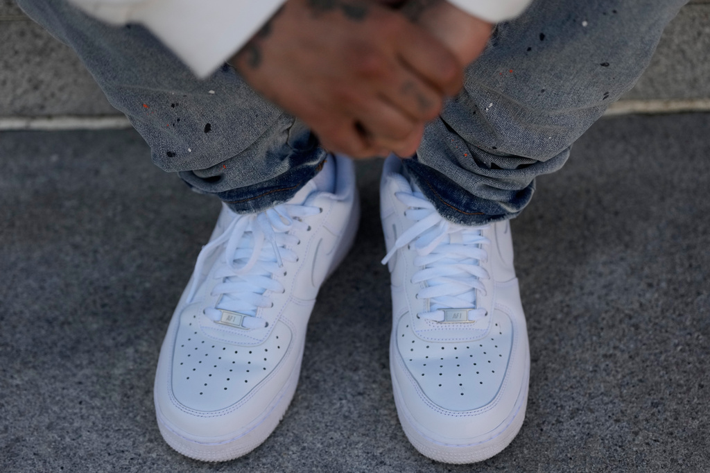 The hands and shoes of Bernard C. are shown during an interview Thursday, April 23, 2026, in Oakland, Calif. (AP Photo/Jeff Chiu)