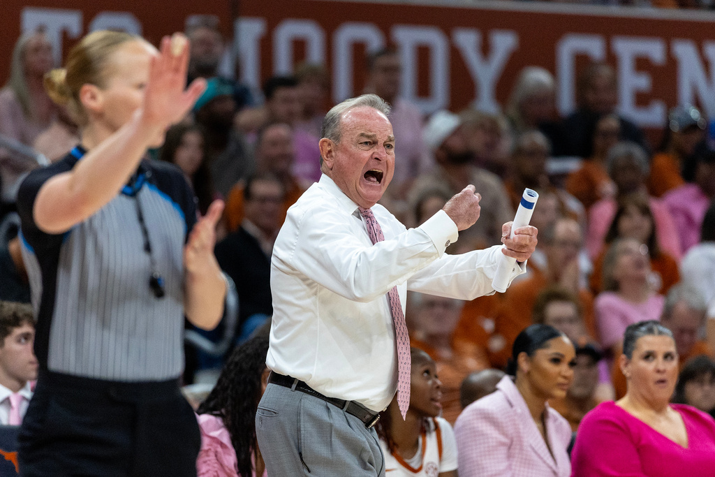 Texas head coach Vic Schaefer, center, calls to his team as they compete against Kentucky during the first half of an NCAA college basketball game Monday, Feb. 9, 2026, in Austin, Texas. (AP Photo/Stephen Spillman)
