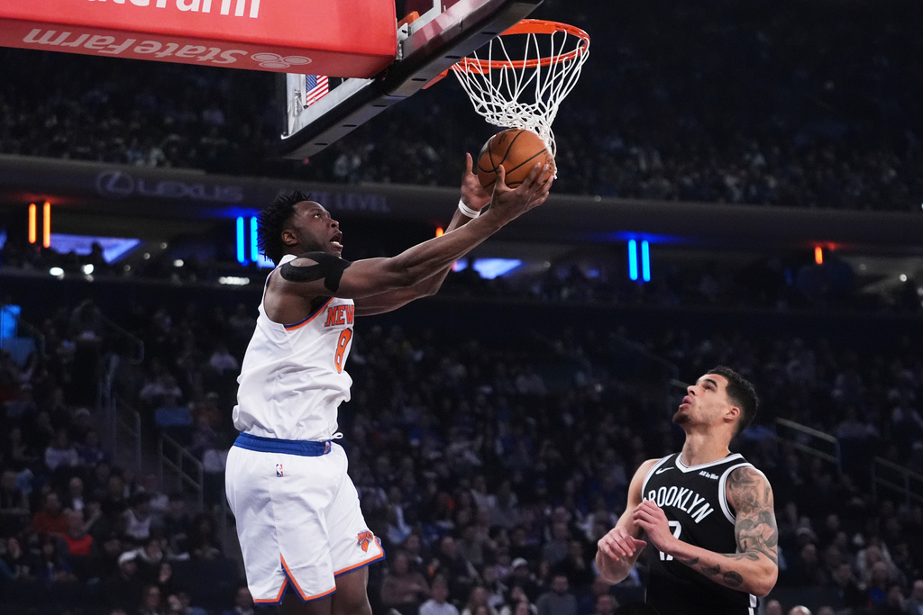New York Knicks' OG Anunoby, left, shoots over Brooklyn Nets' Michael Porter Jr. during the first half of an NBA basketball game Wednesday, Jan. 21, 2026, in New York. (AP Photo/Frank Franklin II)