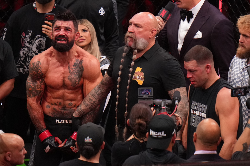 Mike Perry, of the United States, left, celebrates after defeating Nate Diaz, of the United States, right, in their welterweight mixed martial arts fight Saturday, May 16, 2026, in Inglewood, Calif. (AP Photo/Jae C. Hong )