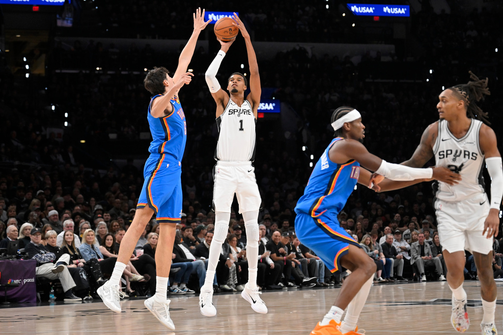 San Antonio Spurs center Victor Wembanyama (1) shoots against Oklahoma City Thunder center Aday Mara during the first half of an NBA basketball game, Tuesday, Oct. 20, 2026, in San Antonio. (AP Photo/Darren Abate)