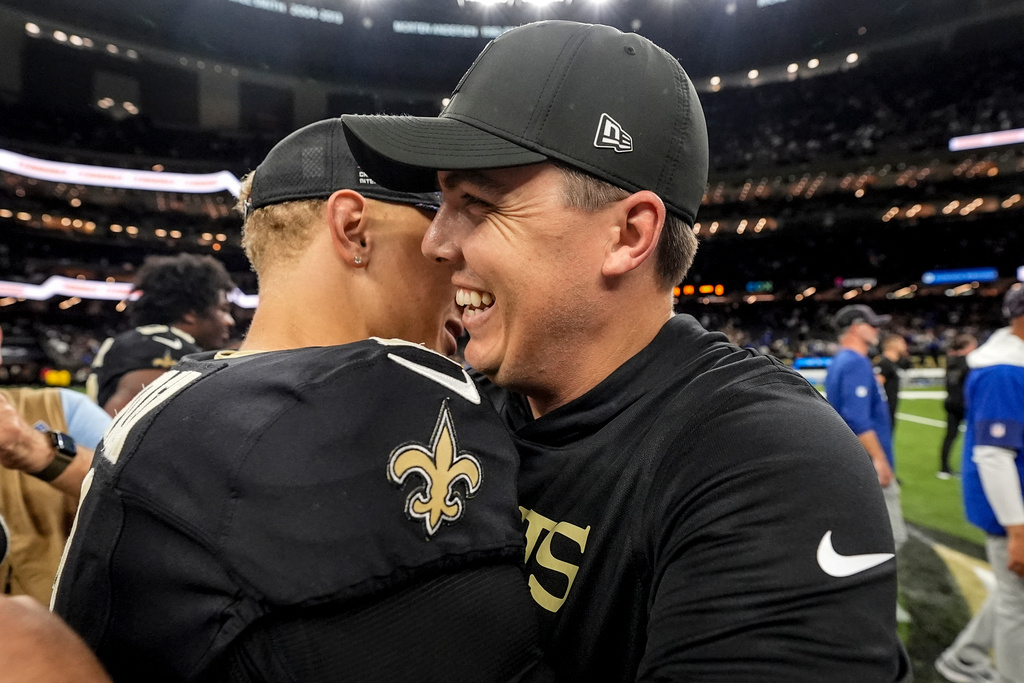 New Orleans Saints head coach Kellen Moore speaks with quarterback Spencer Rattler after an NFL football game against the New York Giants, Sunday, Oct. 5, 2025, in New Orleans. (AP Photo/Gerald Herbert)