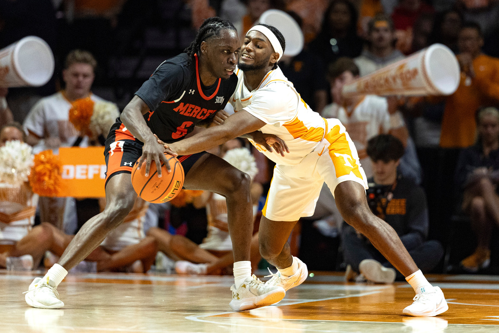 Tennessee guard Amaree Abram (77) tries to steal the ball from Mercer guard Baraka Okojie (6) during the first half of an NCAA college basketball game Monday, Nov. 3, 2025, in Knoxville, Tenn. (AP Photo/Wade Payne)
