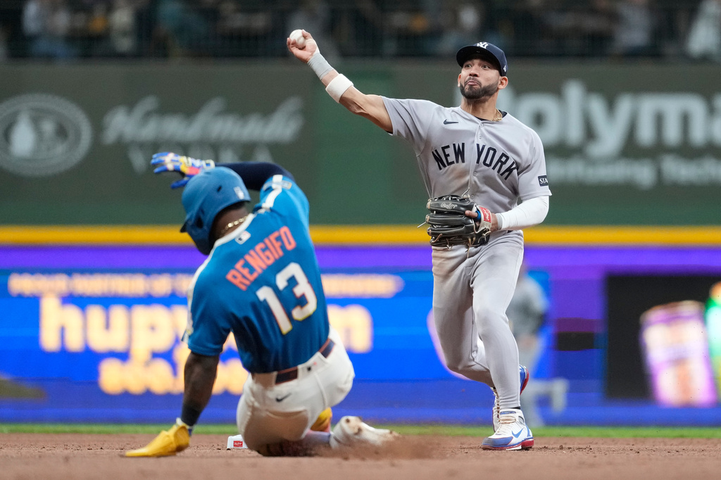 New York Yankees' José Caballero, right, throws to first base to turn a double play after tagging Milwaukee Brewers' Luis Rengifo (13) out at second base during the seventh inning of a baseball game, Friday, May 8, 2026, in Milwaukee. (AP Photo/Aaron Gash)