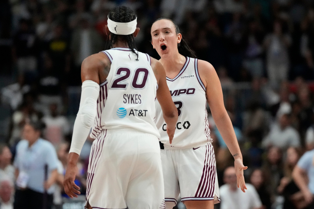 Toronto Tempo's Marina Mabrey (3) and Brittney Sykes (20) celebrate during overtime WNBA action against Connecticut Sun in Toronto, Ontario, Wednesday, June 10, 2026. (Frank Gunn/The Canadian Press via AP)
