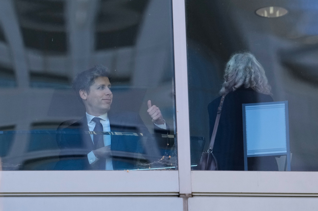 Sam Altman, left, gestures as he walks through a hallway inside the U.S. District Court in Oakland, Calif., Wednesday, April 29, 2026. (AP Photo/Godofredo A. Vásquez)