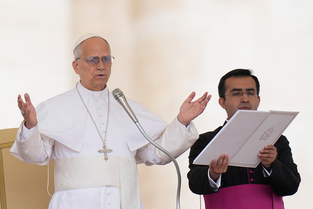Pope Leo XIV, flanked by his secretary Edgard Ivan Rimaycuna Inga, delivers his blessing at the end of his weekly general audience in St. Peter's Square, at the Vatican, Wednesday, May 13, 2026. (AP Photo/Alessandra Tarantino)