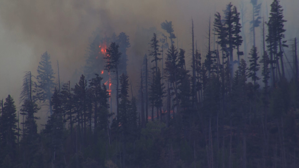 Smoke rises from a fire after a small medical plane crashed in a mountain range outside Ruidoso, New Mexico, on Thursday, May 14, 2026. (KOAT via AP)