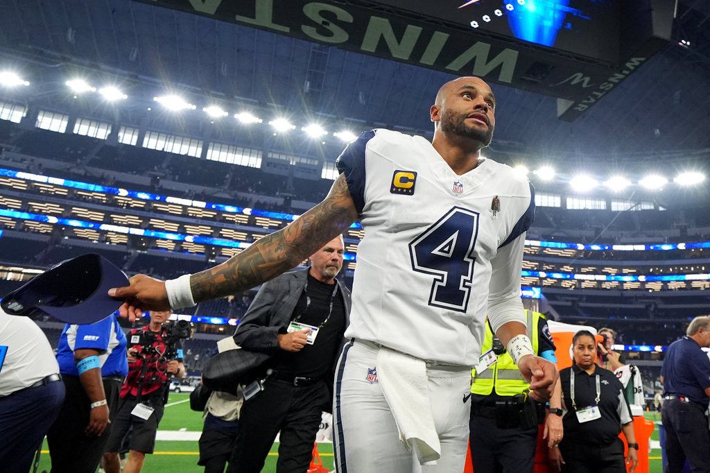 Dallas Cowboys quarterback Dak Prescott (4) leaves the field after an NFL football game against the Washington Commanders in Arlington, Texas, Sunday, Sept. 20, 2026. (AP Photo/Julio Cortez)