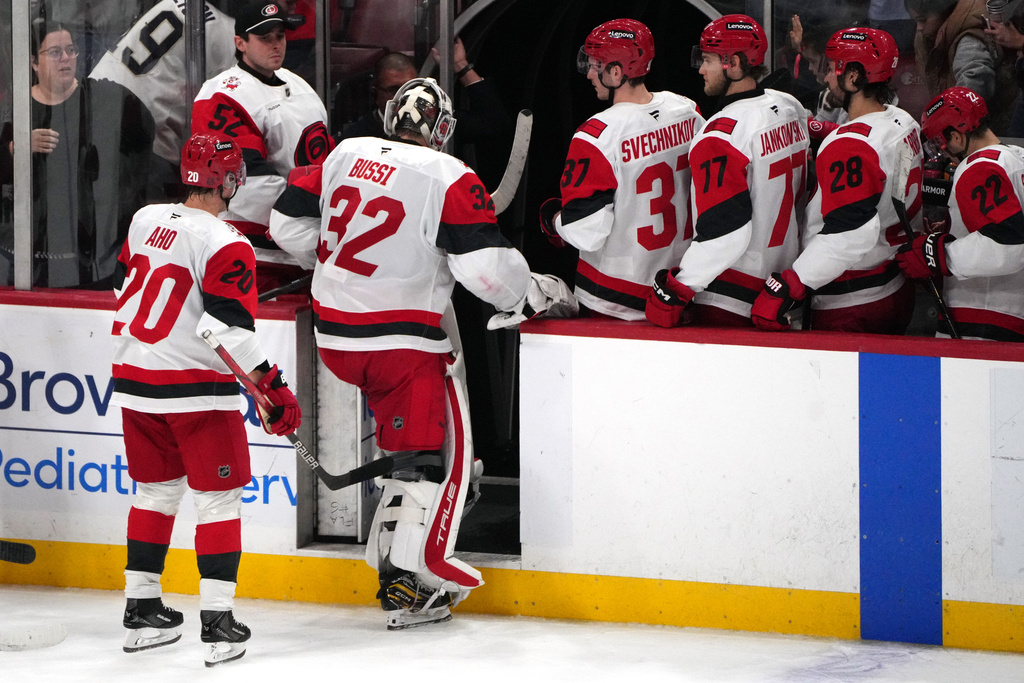 Carolina Hurricanes goaltender Brandon Bussi (32) leaves the ice after losing an NHL hockey game in overtime against the Florida Panthers, Friday, Dec. 19, 2025, in Sunrise, Fla. (AP Photo/Jim Rassol)