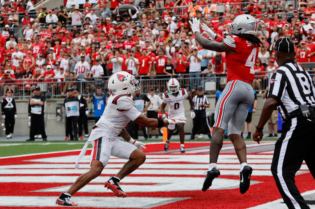 Ohio State wide receiver Jeremiah Smith, right, catches a touchdown pass over Ball State defensive back Sterling Smith during the first half of an NCAA college football game, Saturday, Sept. 5, 2026, in Columbus, Ohio. (AP Photo/Jay LaPrete)