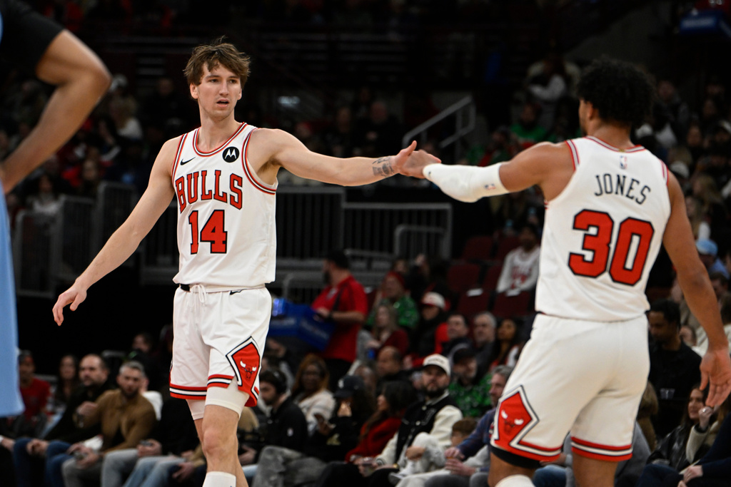 Chicago Bulls' Matas Buzelis (14) celebrates with teammate Tre Jones (30) during the first half of an NBA basketball game against the Memphis Grizzlies in Chicago, Monday, March 16, 2026. (AP Photo/Paul Beaty)