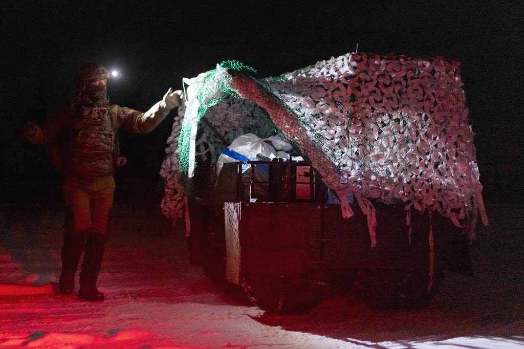 Soldiers from Ukraine's Khartia brigade load ammunition onto a combat ground drone bound for the front line in Kharkiv region, Ukraine, Jan. 27, 2026. (AP Photo/Nikoletta Stoyanova)