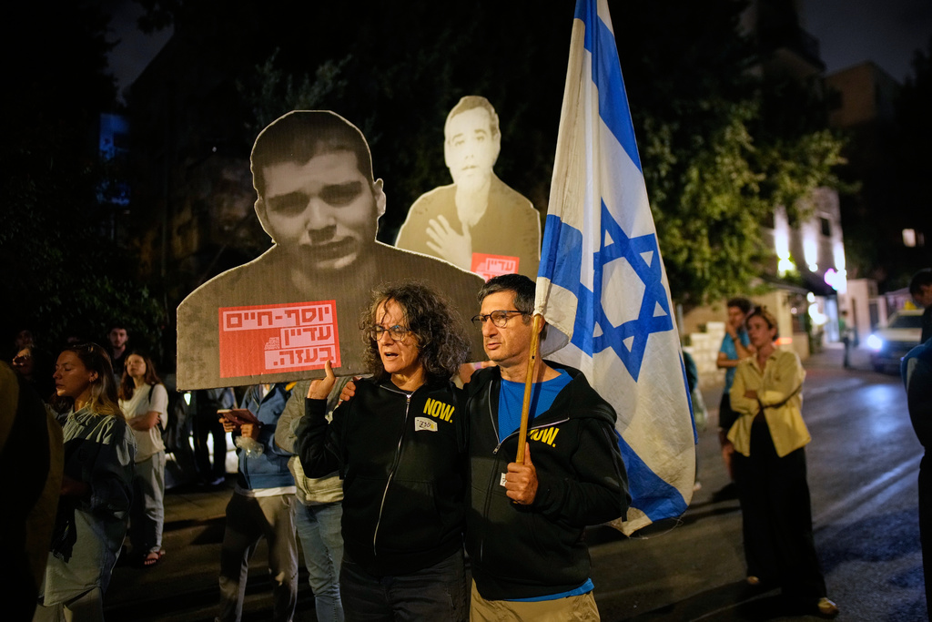 People attend a protest calling for the release of all hostages held by Hamas in the Gaza Strip and urges a ceasefire, outside the Prime Minister's residence in Jerusalem, Sunday, Oct. 5, 2025. (AP Photo/Ohad Zwigenberg)