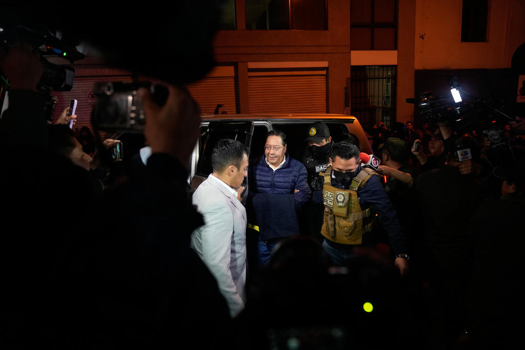 Police officers escort former President Luis Arce to San Pedro Prison after his arrest as part of a corruption investigation in La Paz, Bolivia, Friday, Dec. 12, 2025. (AP Photo/Juan Karita)