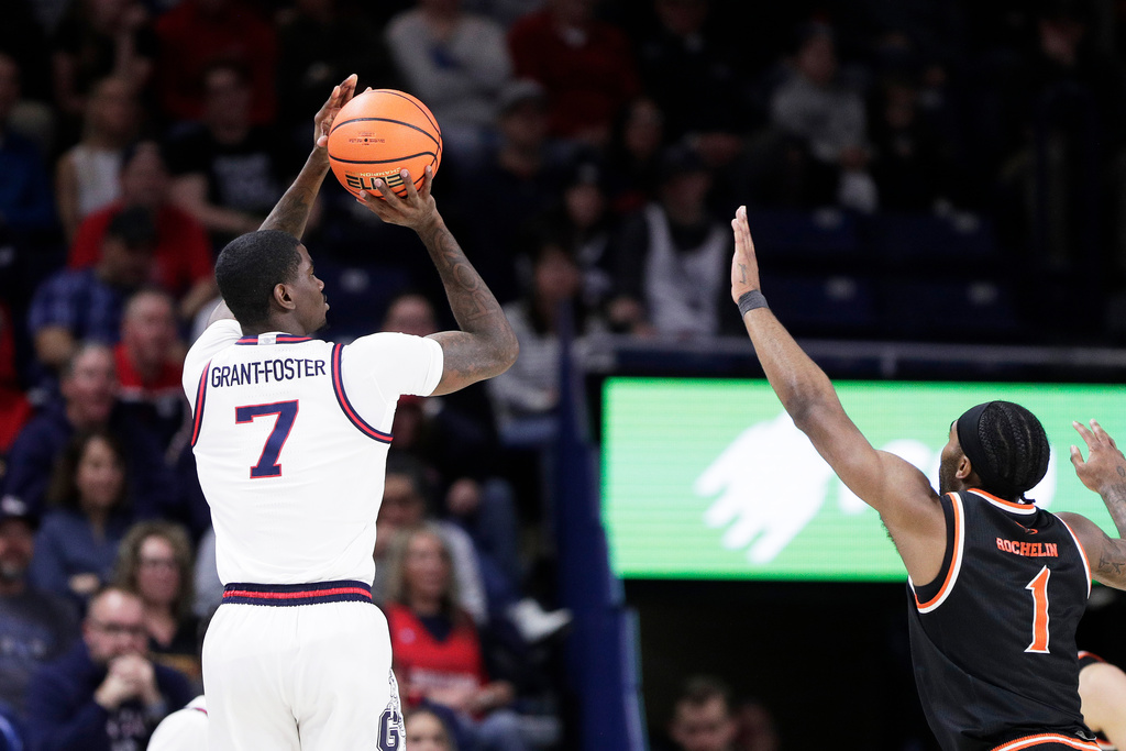 Gonzaga guard Tyon Grant-Foster (7) shoots while pressured by Pacific guard Justin Rochelin (1) during the first half of an NCAA college basketball game Saturday, Feb. 21, 2026, in Spokane, Wash. (AP Photo/Young Kwak)
