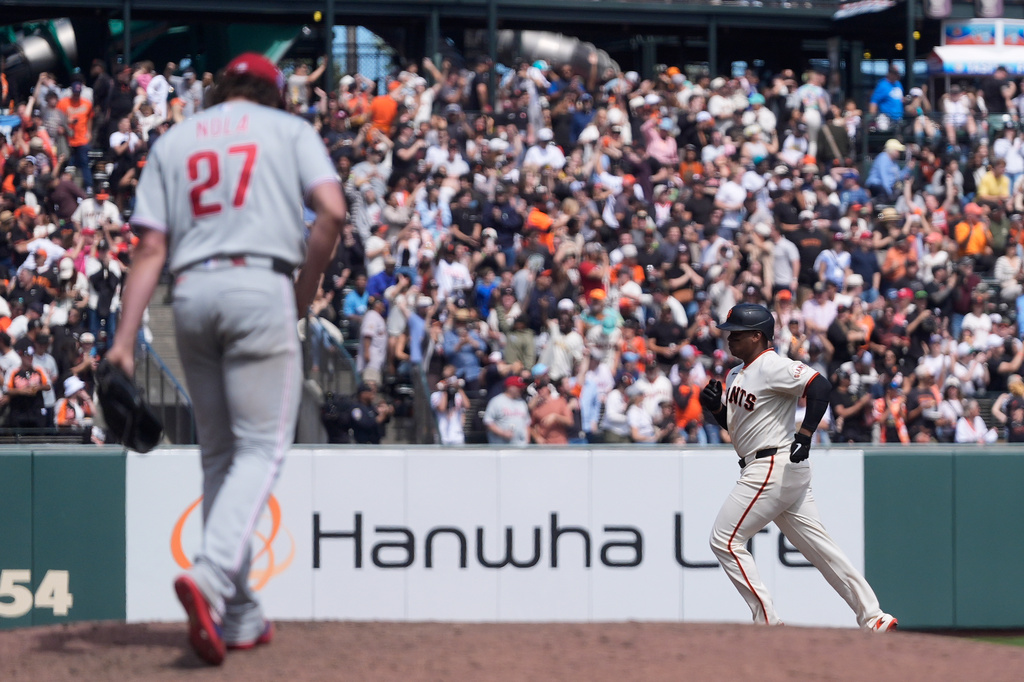 Philadelphia Phillies pitcher Aaron Nola (27) reacts on the mound after allowing a three-run home run to San Francisco Giants' Rafael Devers, right, during the sixth inning of a baseball game in San Francisco, Wednesday, April 8, 2026. (AP Photo/Jeff Chiu)
