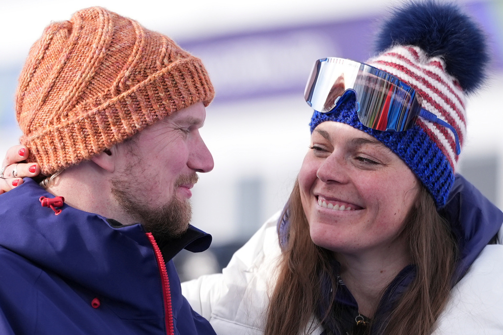 United States' Breezy Johnson, right, and fiancee Connor Watkins smile at each other as they are interviewed after he proposed to her at the end of an alpine ski, women's super-G race, at the 2026 Winter Olympics, in Cortina d'Ampezzo, Italy, Thursday, Feb. 12, 2026. (AP Photo/Jacquelyn Martin)