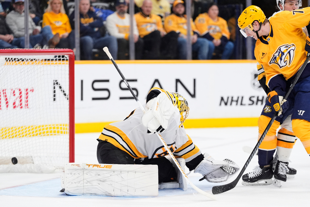Nashville Predators right wing Matthew Wood, right, scores a goal past Boston Bruins goaltender Joonas Korpisalo (70) during the second period of an NHL hockey game Thursday, March 5, 2026, in Nashville, Tenn. (AP Photo/George Walker IV)