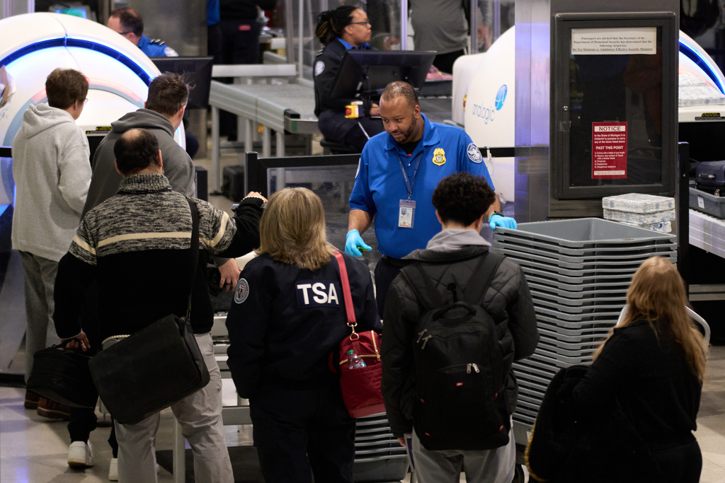 FILE - Travelers wait at a TSA security checkpoint at Detroit Metropolitan Wayne County Airport, Nov. 30, 2025, in Romulus, Mich. (AP Photo/Ryan Sun, File)