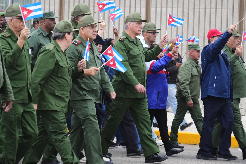 Cuban President Miguel Diaz-Canel marches during a rally to protest the killing of Cuban officers during the U.S. operation in Venezuela that captured Venezuelan President Nicolas Maduro in Havana, Cuba, Friday, Jan. 16, 2026. (AP Photo/Ramon Espinosa)