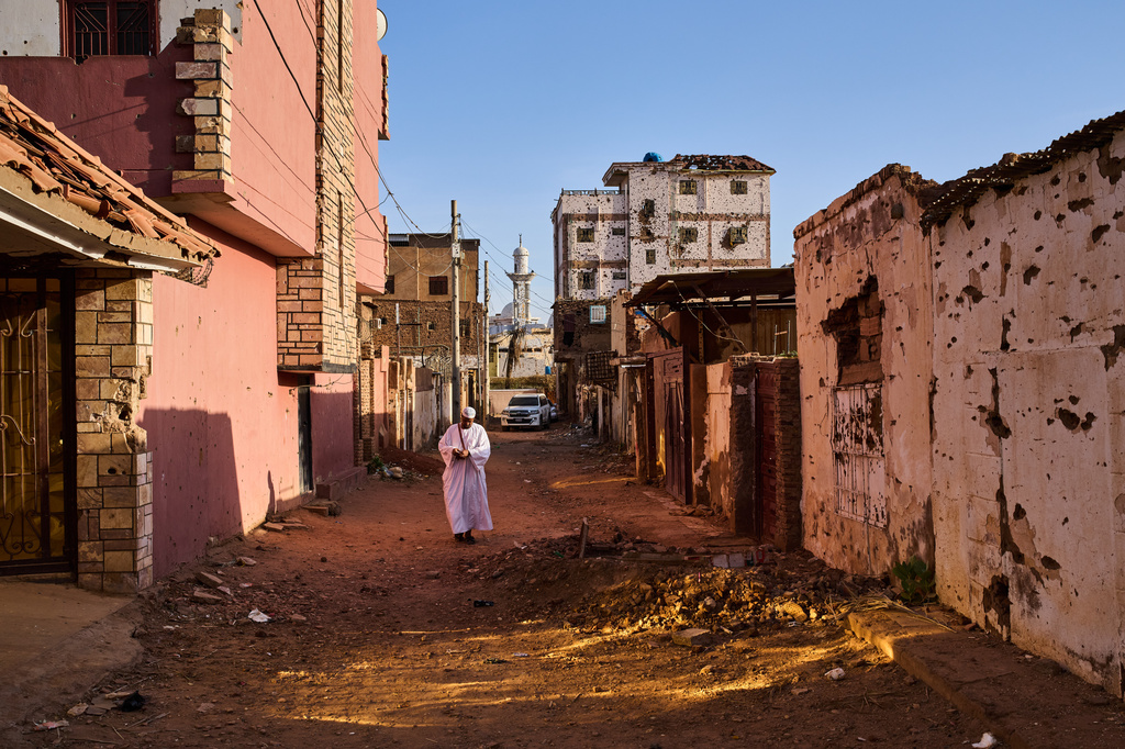A man walks along a street damaged during the war in Omdurman, Sudan, on the outskirts of Khartoum, Friday, April 17, 2026. (AP Photo/Bernat Armangue)
