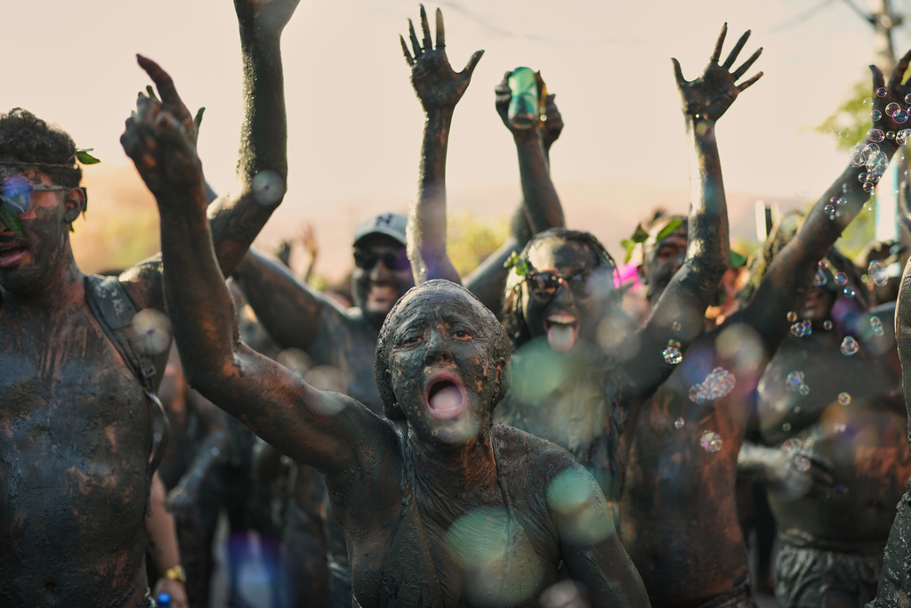 Revelers cheer during the Mud Block carnival party in Paraty, Brazil, Saturday, Feb. 14, 2026. (AP Photo/Andre Penner)