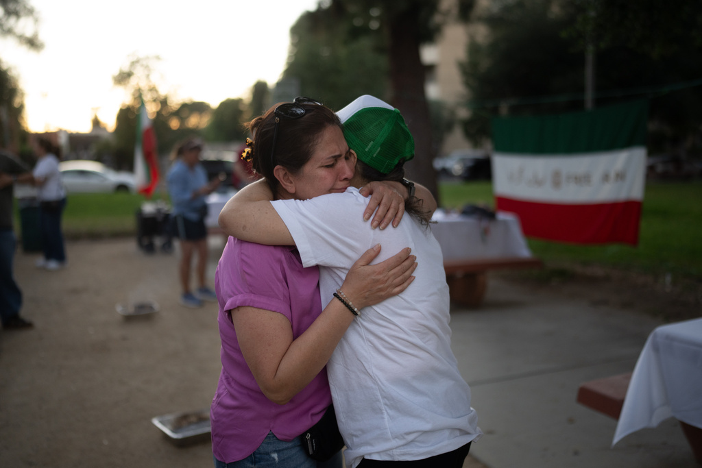 Afsaneh Nasrollahi, left, sobs as she is embraced by Mahahidi Farmaz during a community gathering ahead of the Nowruz holiday in the Encino neighborhood of Los Angeles, March 17, 2026. (AP Photo/Jae C. Hong)