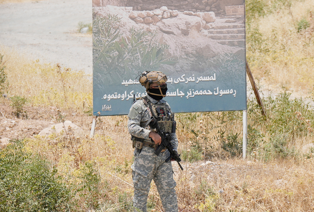 FILE - Forces of the regional Kurdish administration secure the area of the Jasana Cave ahead of a symbolic disarmament ceremony by the separatist PKK group as part of the peace process with Turkey, in Sulaymaniyah governorate, Iraq, July 11, 2025. (AP Photo/Hadi Mizban, File)