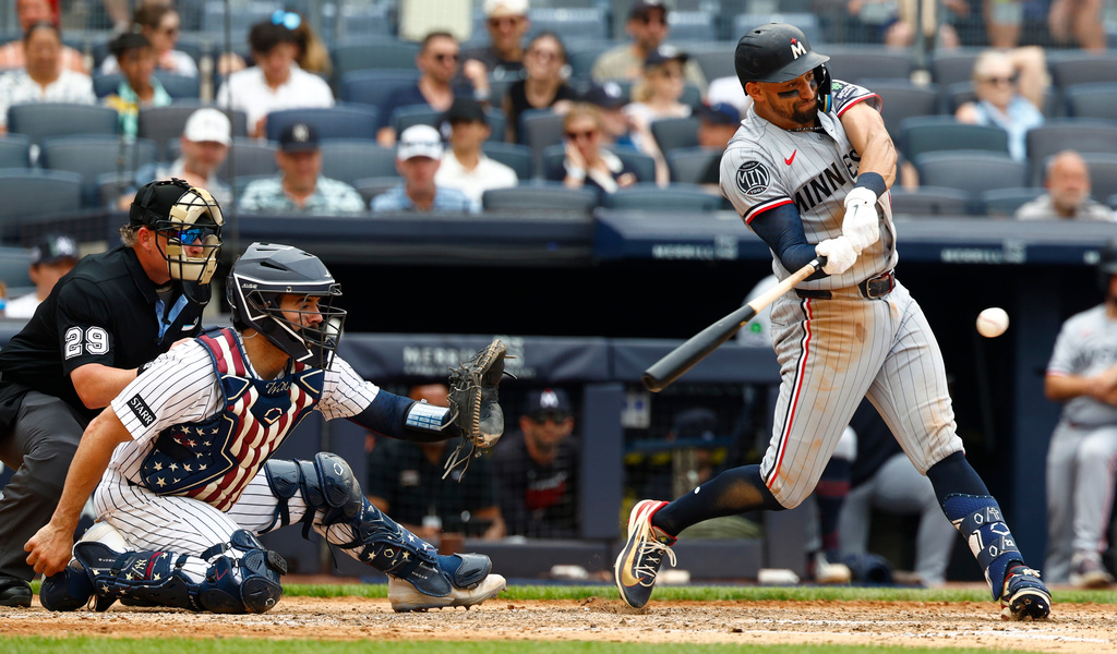 Minnesota Twins' Royce Lewis, right, hits an RBI single against the New York Yankees during the fifth inning of a baseball game, Sunday, July 5, 2026, in New York. (AP Photo/Noah K. Murray)