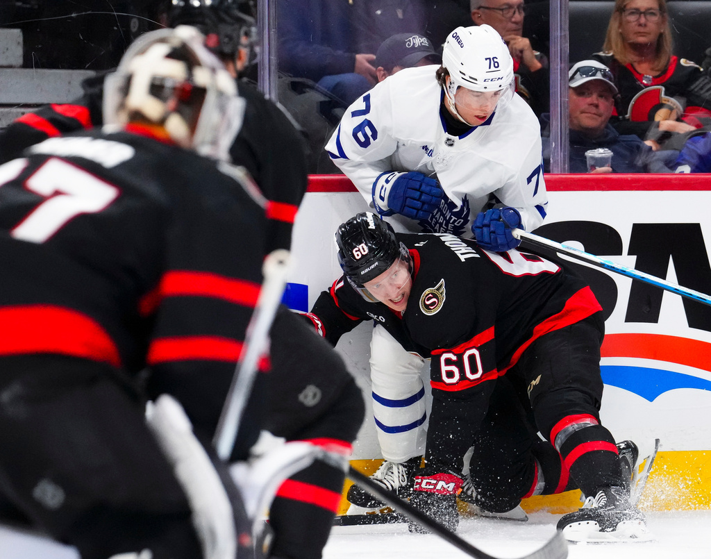 Toronto Maple Leafs' William Villeneuve (76) pushes Ottawa Senators' Lassi Thomson (60) to the ice during the first period of an NHL hockey game in Ottawa, Ontario, on Wednesday, April 15, 2026. (Sean Kilpatrick/The Canadian Press via AP)