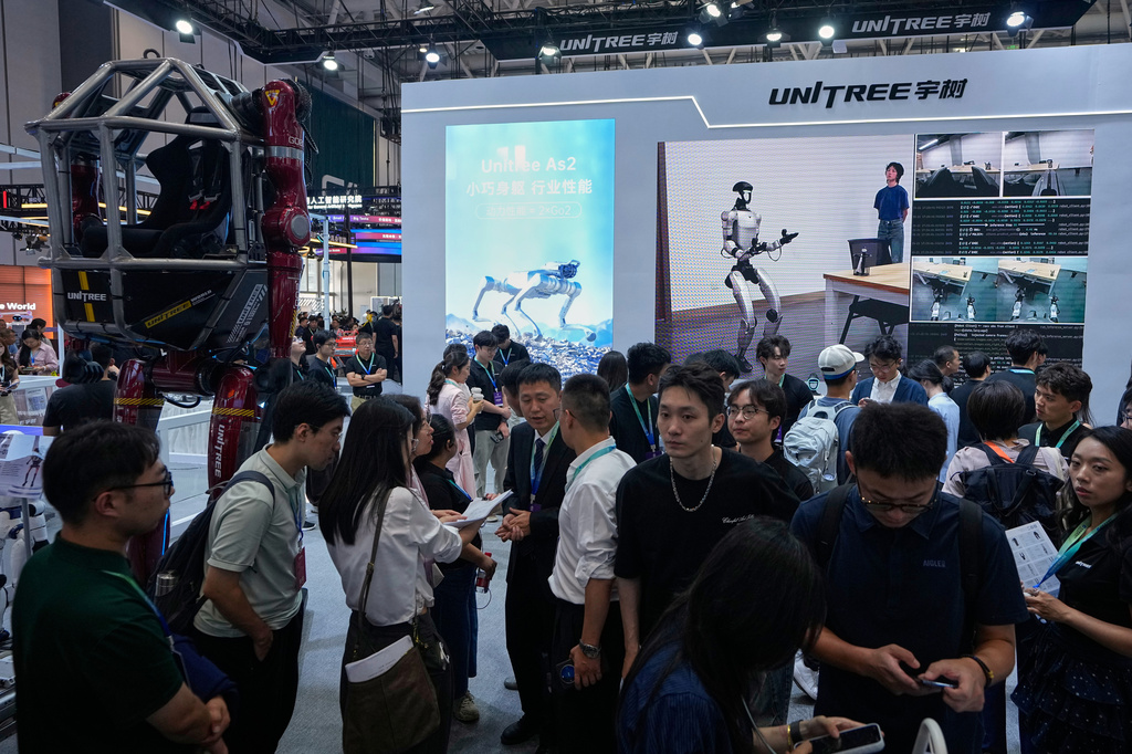 People visit a booth of Unitree, one of China's largest humanoid robot makers, during the World Robot Conference at the Beijing Yichuang International Convention and Exhibition Centre in Beijing, Wednesday, Aug. 19, 2026. (AP Photo/Andy Wong)