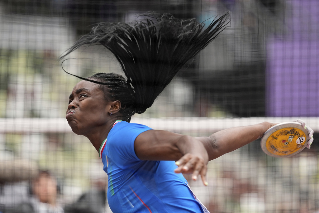 Italy's Daisy Osakue makes an attempt in the women's discus throw qualification at the World Athletics Championships in Tokyo, Saturday, Sept. 13, 2025. (AP Photo/Matthias Schrader)