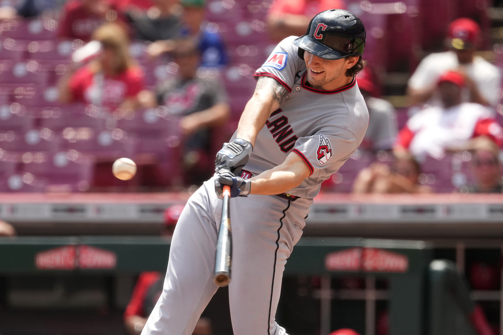 Cleveland Guardians' Chase DeLauter hits a one-run sacrifice fly ball during the fifth inning in the first baseball game of a doubleheader against the Cincinnati Reds, Tuesday, July 28, 2026, in Cincinnati. (AP Photo/Kareem Elgazzar)