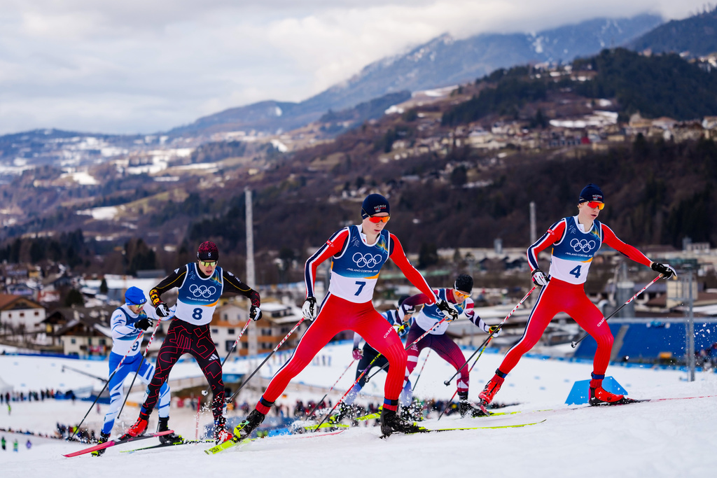Einar Luraas Oftebro, of Norway, right, Jens Luraas Oftebro, of Norway, center, and Vinzenz Geiger, of Germany, left, compete in the Nordic Combined Individual Gundersen Normal Hill/10km competition at the 2026 Winter Olympics, in Tesero, Italy, Wednesday, Feb. 11, 2026. (AP Photo/Evgeniy Maloletka)