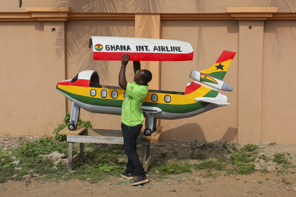 Eric Kpakpo Adotey displays an aeroplane fantasy coffin in front of his shop in La, Accra, Ghana, Friday, July 25, 2025. (AP Photo/Misper Apawu)
