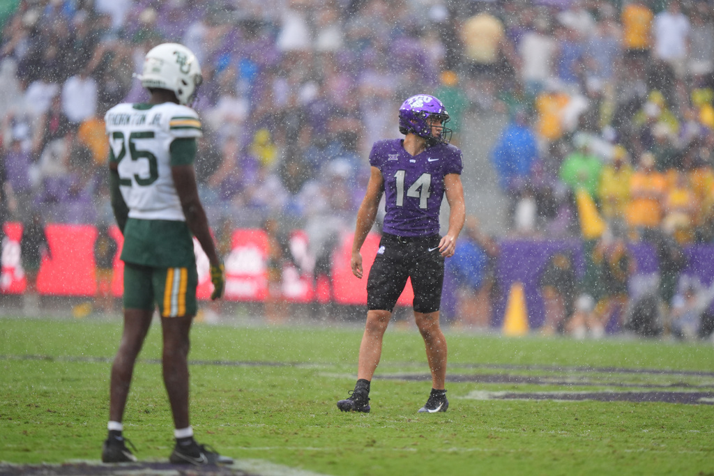 TCU wide receiver Joseph Manjack IV (14) lines up against Baylor cornerback Levar Thornton Jr. (25) as rain falls during the first half of an NCAA college football game, Saturday, Oct. 18, 2025, in Fort Worth, Texas. (AP Photo/LM Otero)